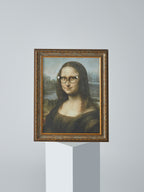DAMNARTS Mona Lisa glasses holder displayed on a pedestal with round optical glasses, highlighting art and function.