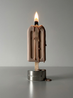DAMNARTS Desert Sand scented ice pop candle burning with melting wax dripping