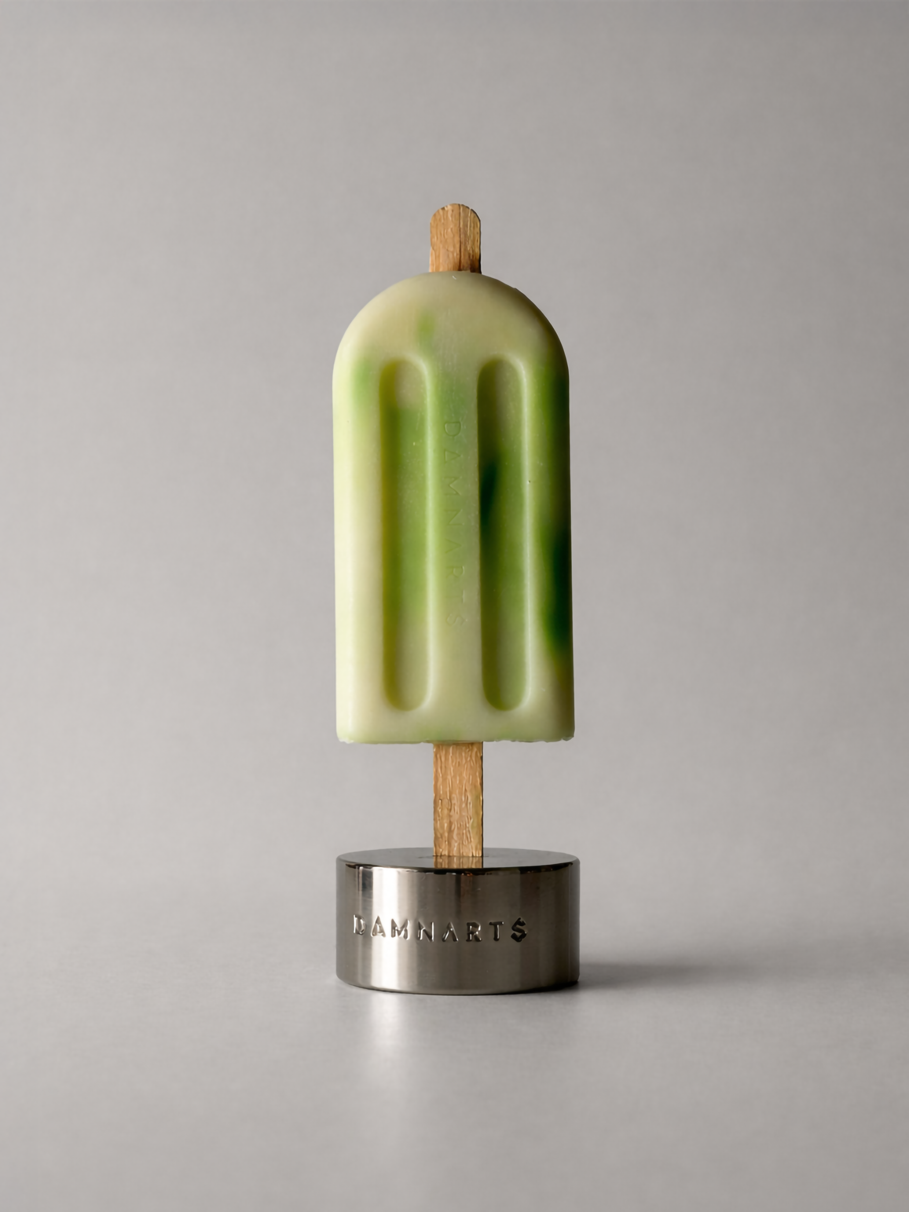 DAMNARTS Forest Mist scented ice pop candle on metal base, minimalist product shot