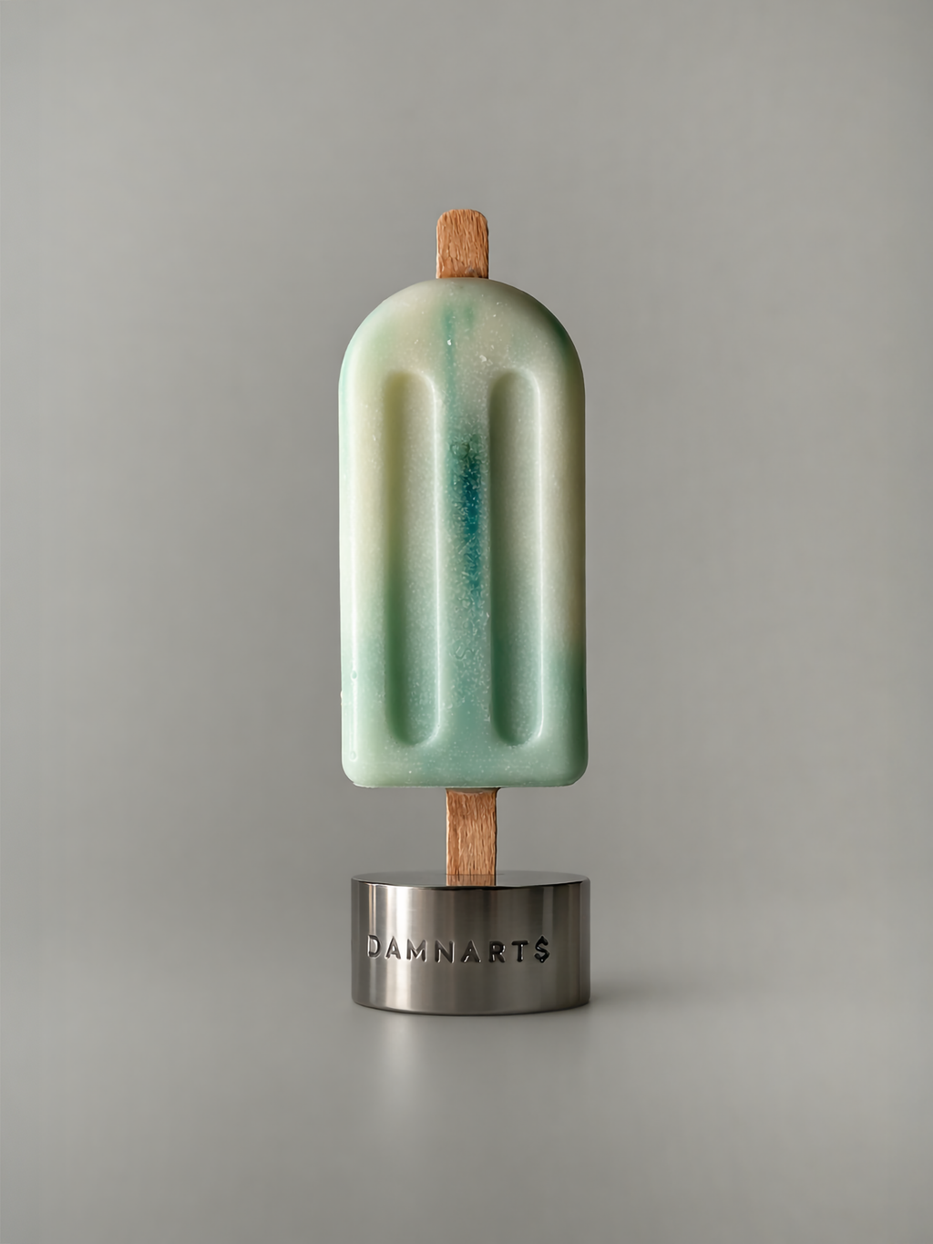 DAMNARTS Ocean Breeze scented ice pop candle on metal base, minimalist product shot
