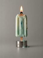  DAMNARTS Ocean Breeze scented ice pop candle burning with melting wax dripping