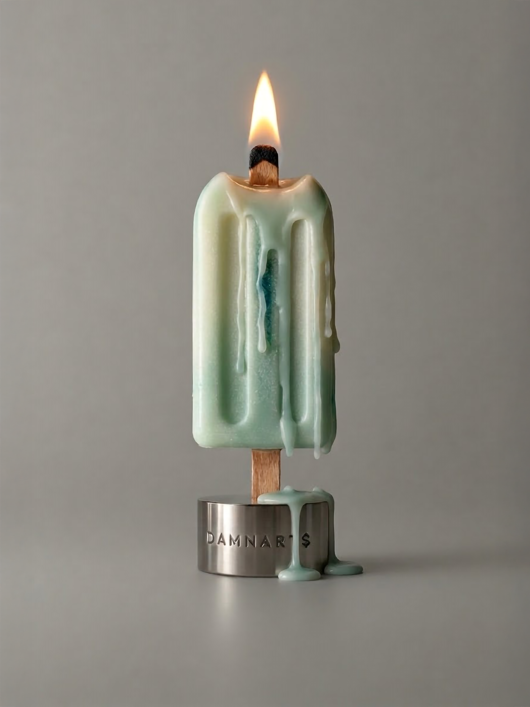 DAMNARTS Ocean Breeze scented ice pop candle burning with melting wax dripping