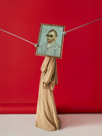 DAMNARTS Vincent van Gogh glasses holder photographed against a red background, featuring sunglasses on the framed artwork as a wearable display.